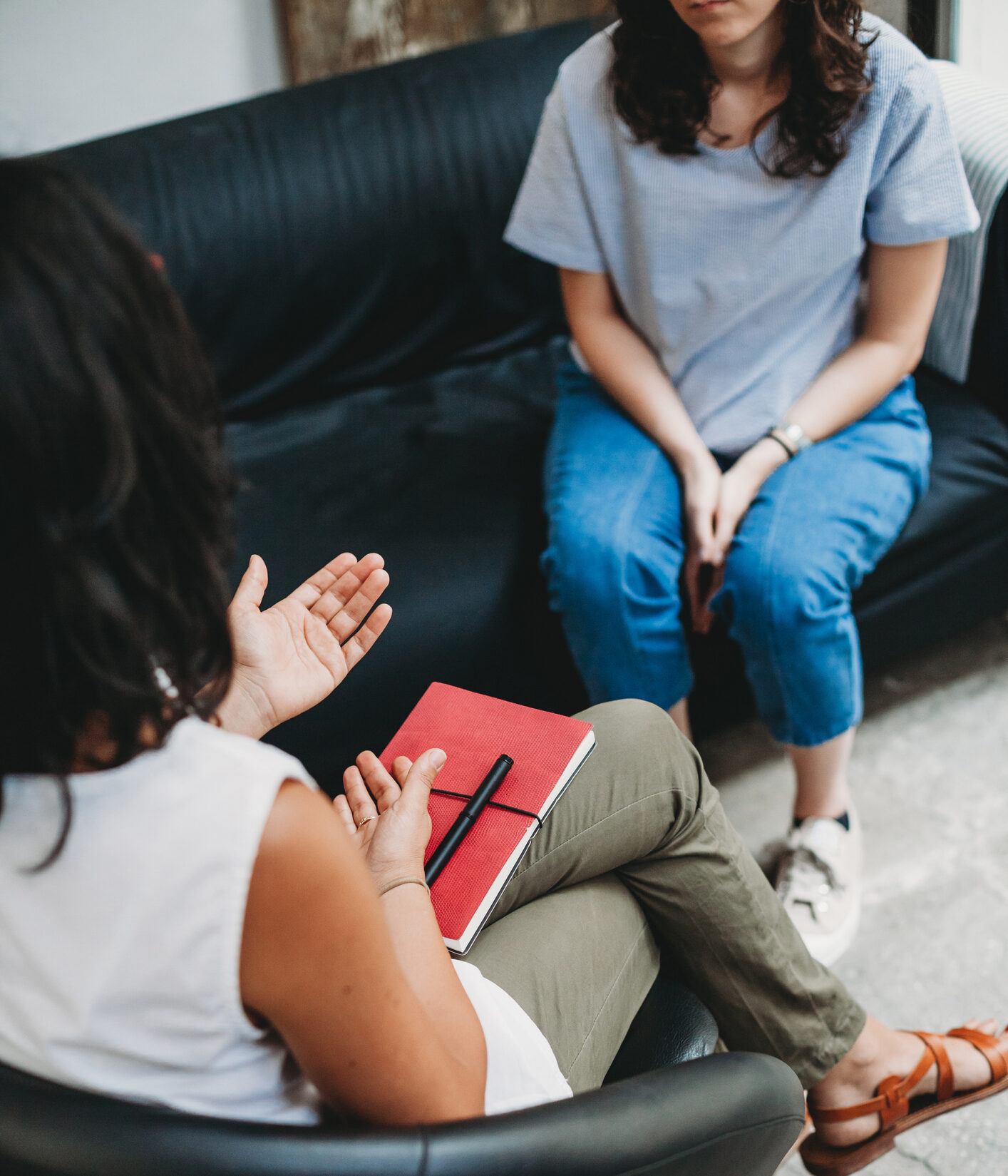 Psychotherapy session, woman talking to his psychologist in the studio